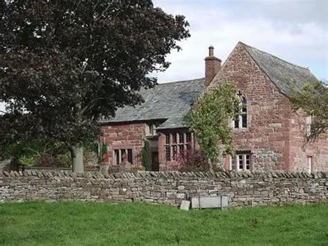 Kirkby Thore Hall, a historic red sandstone house with slate roof and stone walls, set in the Eden Valley.